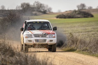 Madrid, İspanya; 02-15-2025: Mitsubishi Montero DiD ralli SUV, dramatik bir ön ralli vuruşuyla egzozundan yükselen siyah dumanla toprak bir pistte patlıyor