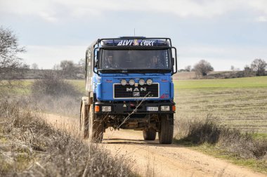 Madrid, İspanya; 02-15-2025: Dakar ralli kamyonu, Man F2000 4.22 modeli, toprak yolda ilerliyor, toprak rali safhasında toz kaldırıyor.