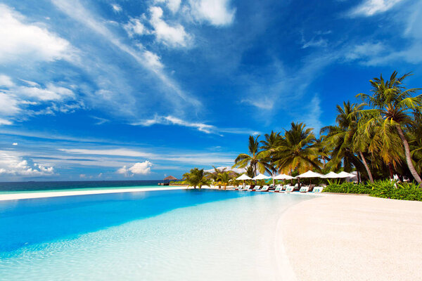 tropical beach in maldives with blue sky and sea