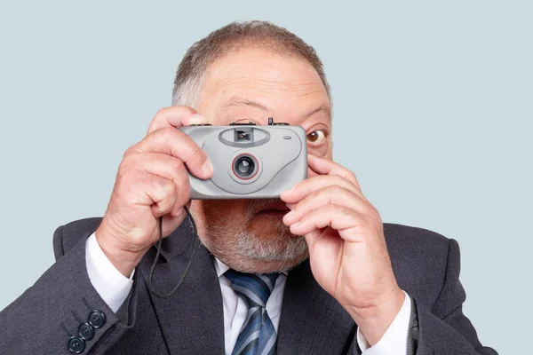 Işıklı arkaplanda eski kompakt kamerayla fotoğraf çekimi