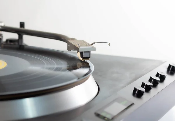 Close-up of a vintage record player, playing a black long-player record