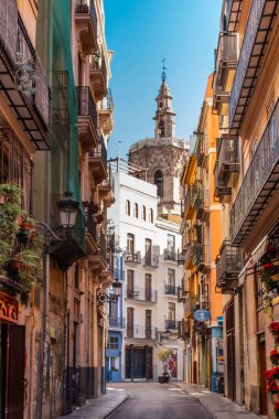 Valencia, İspanya - 19 Kasım 2023: Arkasında Al Miguelete anıtı olan bir şehrin tarihi merkezinde el değmemiş bir cadde