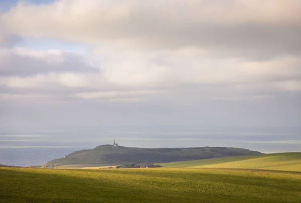 Calm peaceful midday view of Belle Tout lighthouse from Beachy Head on the south downs coast east Sussex south east England UK