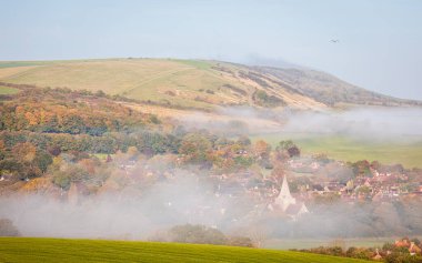 Autumn misty morning sunrises near Alfriston village nestled in the cuckmere valley of the south downs East Sussex south east England UK clipart