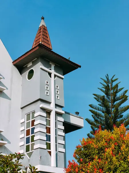 stock image Surabaya-Indonesia, May 18, 2024.Front view architectural detail of an Indonesian tropical style Catholic Church. Photographed on a sunny morning.