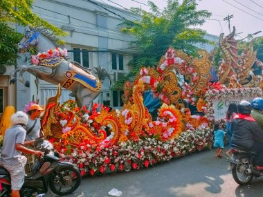 Surabaya - Indonesia, May 26, 2024.The Flower Parade event at Surabaya Vaganza, featuring flower floats car being prepared for the city center of Surabaya. clipart