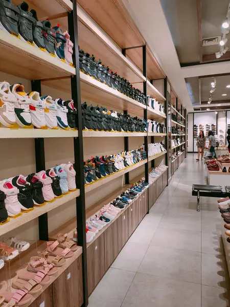 stock image Surabaya - Indonesia, May 26, 2024.The interior of the Shoe Shop is modern in design, with rows of display racks, show cases that attract visitors' attention.