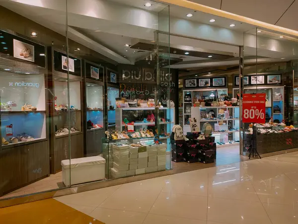 stock image Surabaya - Indonesia, June 14, 2024.Front view of the Shoe store with a modern design, attractive with spatial layout and lighting and extensive use of glass as transparency. Eye level view.