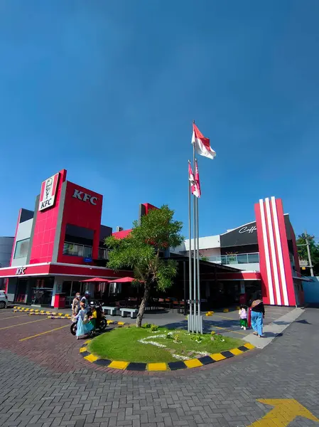 Surabaya - Endonezya, 26 Temmuz 2024 Kırmızı ve Beyaz bayrak, Endonezya 'nın Bağımsızlık Günü kutlamalarında bir fast food restoranının önünde gururla dalgalanıyor. Balık bakışı.