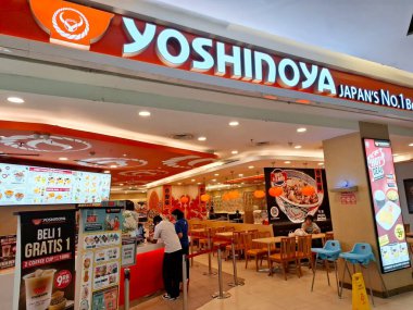 Surabaya - Endonezya, 9 Ekim 2024 Japon atmosferi, hafif ve çekici ahşap elementlerle birlikte Yoshinoya Restoranı manzarası. Göz düzeyi görünümü.