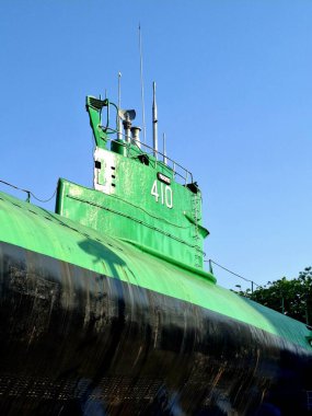 Surabaya - Indonesia, October 27, 2024.Exterior side view of the Conning Tower of the Submarine Pasopati at the Surabaya Submarine Monument Museum. Low view level, in the afternoon. clipart