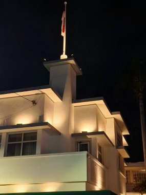 Surabaya - Indonesia, November 9, 2024.The location of the tearing of the Dutch Blue Red and White flag into the Indonesian Red and White flag on the roof of Majapahit Hotel or Orange Hotel. At night, low level angle. clipart