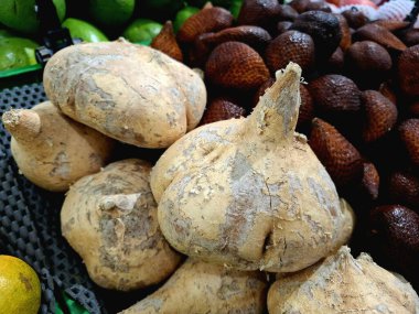 Fresh Pachyrhizus erosus Bengkuang fruit arranged to attract shoppers at a supermarket. clipart