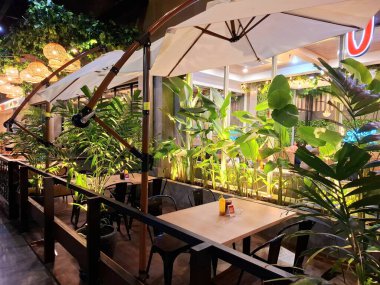 Sidoarjo, Endonezya, 9 Mayıs 2025. Pan & Flip restoranının ön görüntüsü, yemek alanında bitki unsurları barındırıyor, verimli bir atmosfer yaratıyor. Geceleri göz hizası görüntüsü.