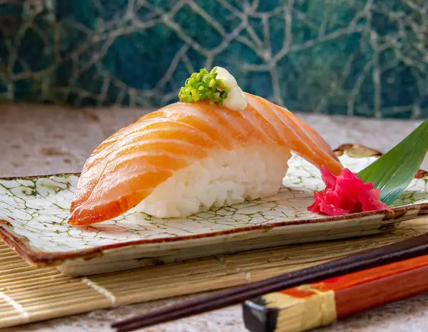 a Japanese sushi dish, one exquisite piece of nigiri, with focus on the fish texture