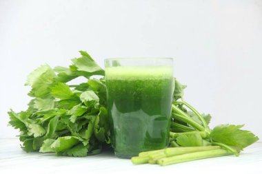 Kereviz suyu, kerevizden yapılmış sağlıklı yeşil içecek taze yeşil kereviz yapraklarıyla süslenmiş yeşil kereviz suyu.