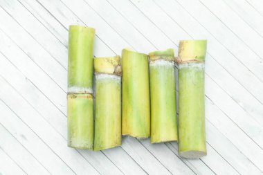 Sarı şeker kamışı sapları veya Saccharum officinarum beyaz arka planda düzenlenmiş ve izole edilmiş