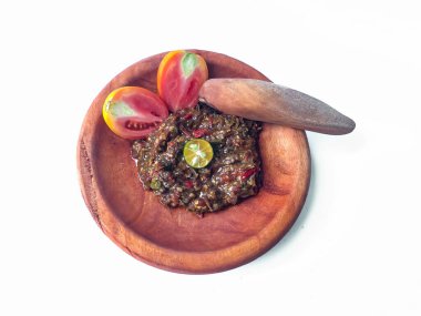 Terasili acı biber sosu ya da kabuklu karides ezmesi ya da Endonezyalıların genellikle otları ve baharatları öğütmek için kullandıkları geleneksel bir araç, beyaz arkaplanlı terasili kırmızı biber sosu.