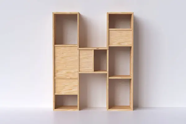3D wood letter H made of pine plywood planks. Shelving design style nice to display books, decorative items or products for sale. 3D rendering