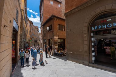 Siena, Italy - June 01, 2024: Touristic street. Sephora perfume shop on the foreground. clipart