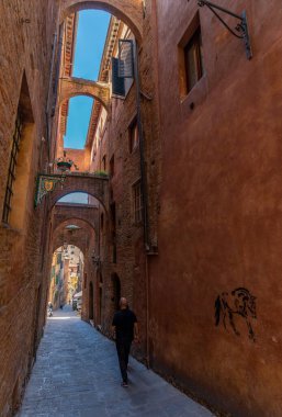 Siena, Italy - June 01, 2024: Beautiful street of siena. Bottom to top view. clipart