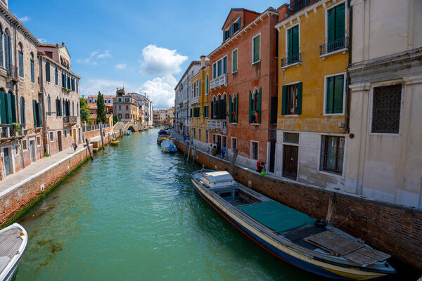 Venice, Italy - June 05, 2024: Venice, Italy - June 05, 2024: Peaceful Venice Canal with Docked Boats.