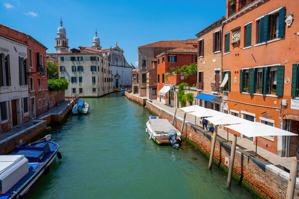 Venice, Italy - June 05, 2024: Venice Canal Scene with Church in the Background.