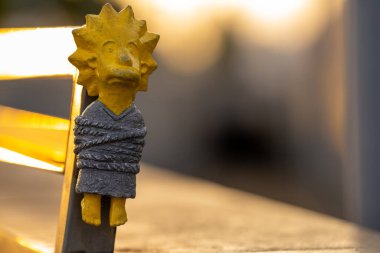 Budapest, Hungary: July 07, 2024: Kolodko, tied Lisa Simpson sculpture. Sunset golden light on the background. Close up shot. clipart