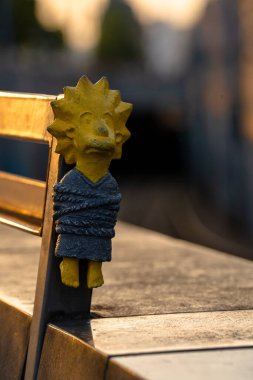 Budapest, Hungary: July 07, 2024: Kolodko, tied Lisa Simpson sculpture. Sunset golden light on the background. clipart