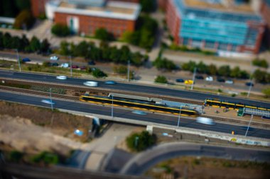 Budapest, Hungary - August 24, 2024: Cars traffic on Dombovari street road. Focus shifted to the road with tilt shifted lend. clipart