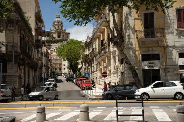 Messina, Italy - May 21, 2024: Via Enrico Martinez Street in Messina Overlooking the Iconic Tempio di Cristo Re on the Horizon clipart