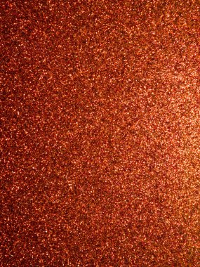 Işıltılı turuncu parıltılı arkaplan arkaplanının yakın plan fotoğrafı, şenlikli ve göz alıcı bir zemin oluşturuyor. Tatil tasarımlarında, parti davetiyelerinde, el sanatlarında ve canlı ve parıltılı bir yüzey gerektiren ticari projelerde kullanım için idealdir..
