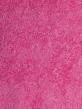 Yumuşak pembe havlu kumaşının detaylı kıvrımlı dokusunu gösteren makro yakın çekim fotoğrafı. Görüntü kumaşları kabarık ve emici yüzeyleri yakalar, arka plan, dizayn ve tekstil temaları için idealdir. Burada kimse yok..