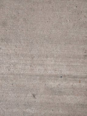 Detailed photo of a gray concrete surface showing its rough texture, subtle horizontal lines, and small specks. This image serves as a versatile background or texture for architectural, construction, or design projects.