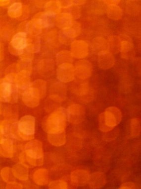 Abstract photo featuring a vibrant orange bokeh background with soft, out-of-focus circular light patterns. Suitable for festive, creative, or seasonal designs, this image provides a warm and inviting visual texture that works well for overlays