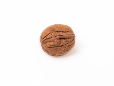 Single whole walnut in its brown shell centered on a clean white background. The nut features a rough, textured surface, making it ideal for themes related to healthy eating, natural food, nutrition, and autumn harvest.