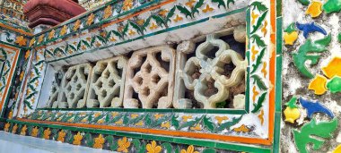 Bangkok, Thailand - Sept 14, 2024: Colorful wall decoration in Khao Klang Nok Great Stupa in Wat Arun Ratchawararam Ratchawaramahawihan temple clipart