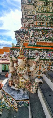 Bangkok, Thailand - Sept 14, 2024: Colorful wall decoration in Khao Klang Nok Great Stupa in Wat Arun Ratchawararam Ratchawaramahawihan temple clipart