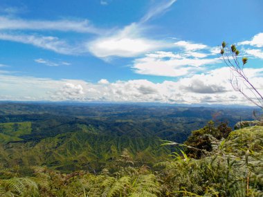 Güneşli bir günde, arka planda büyük, güzel dağlar olan manzara bulutlar ve mavi gökyüzü..