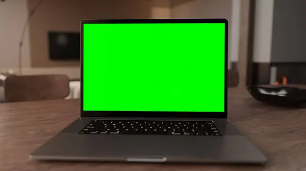 3D Laptop with green screen on display in home office. High quality photo