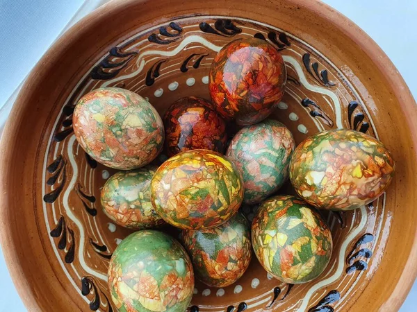 Easter eggs on a ceramic plate. In Ukraine, there is a long tradition of painting eggs for Easter, blessing them and decorating the Easter table. Easter eggs in the Carpathians are especially beautifully and brightly colored and are called pysanky...