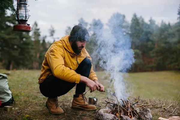 Survival Wild Bearded Man Lights Fire Makeshift Shelter Made Pine — Stock Photo, Image
