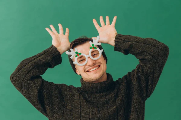 Young Man Warm Sweater Cap Carnival Glasses Isolated Green Background — Stock Photo, Image