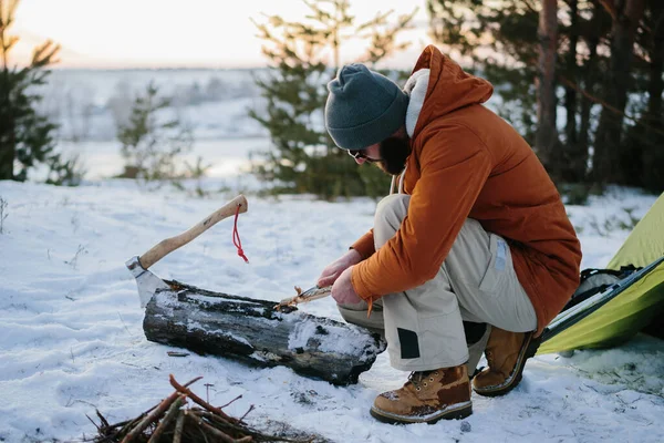 Man Prepares Wood Wool Knife Starting Fire Winter Forest Sunset — Stock Photo, Image