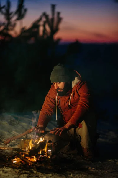 Ein Mann Sitzt Der Nähe Eines Lagerfeuers Und Wärmt Sich — Stockfoto