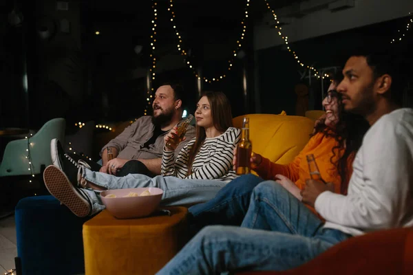 Company Multiracial Friends Watching Movie Sitting Soft Bean Bags Drinking — Stock Photo, Image