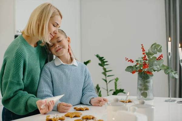 Young Happy Mother Hugs Her Little Daughter Kitchen While Making — Stock Photo, Image