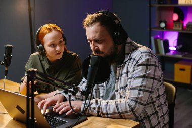 Radyo sunucusu stüdyo konuğuna dinleyicilerin sorularını okur. Çevrimiçi ortam kavramı.