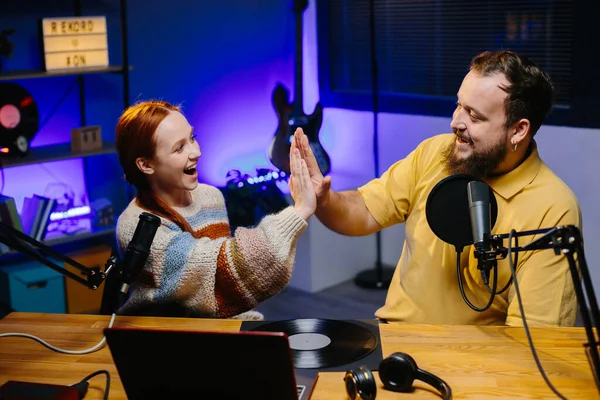 Man having conversation with woman in internet broadcast using professional microphone and audio mixer. Online radio station host recording podcast interviewing guest in late night talk show.