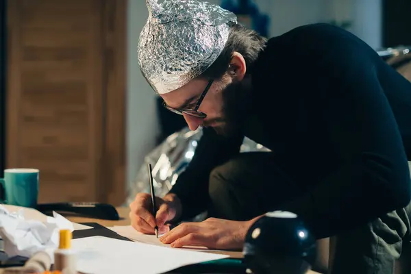 Unveiling Conspiracies Man Foil Hat Crafting Cryptic Signs — Stock Photo, Image